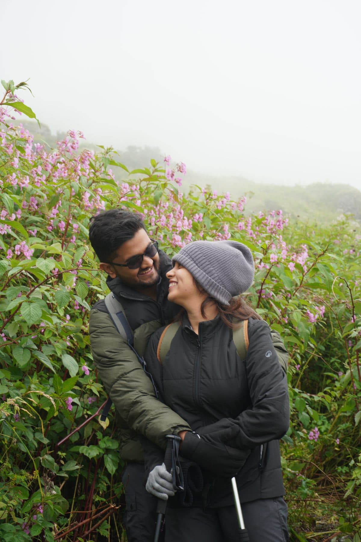 Sudhanva and Sneha hugging in the misty hills
